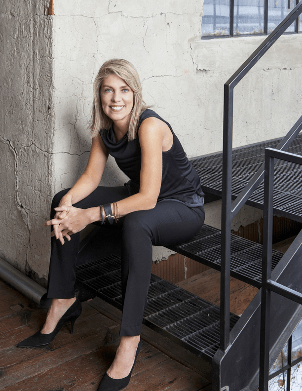 top nyc interior designer sitting on black steps in black outfit